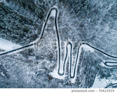 Seasons Concept winter snowy Aerial view Winding road serpentine mountain pass village Brodenbach Germany Seasons Concept winter snowy Aerial view Winding road serpentine mountain pass village Brodenbach Germany 70422919