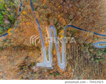 Seasons Concept winter or fall Aerial view Winding road serpentine mountain pass village Brodenbach Germany Seasons Concept winter or fall Aerial view Winding road serpentine mountain pass village Brodenbach Germany 70422923