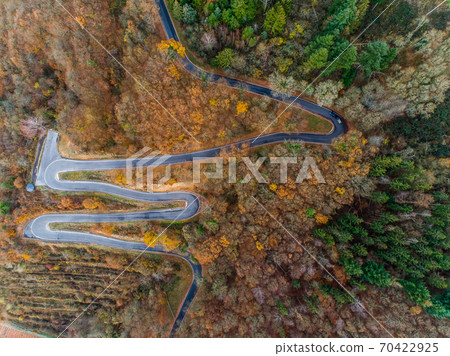 Seasons Concept winter or fall Aerial view Winding road serpentine mountain pass village Brodenbach Germany Seasons Concept winter or fall Aerial view Winding road serpentine mountain pass village Brodenbach Germany 70422925