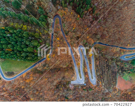 Seasons Concept winter or fall Aerial view Winding road serpentine mountain pass village Brodenbach Germany 70422927