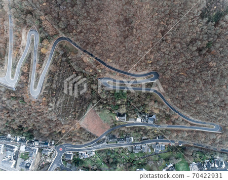 Seasons Concept winter or fall Aerial view Winding road serpentine mountain pass village Brodenbach Germany Seasons Concept winter or fall Aerial view Winding road serpentine mountain pass village Brodenbach Germany 70422931