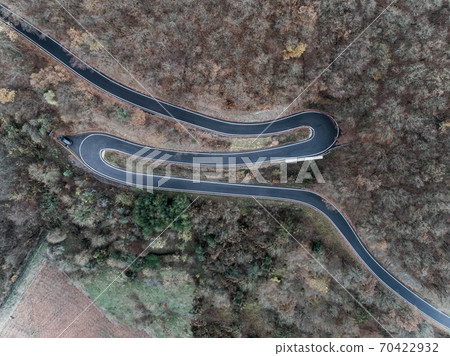 Seasons Concept winter or fall Aerial view Winding road serpentine mountain pass village Brodenbach Germany Seasons Concept winter or fall Aerial view Winding road serpentine mountain pass village Brodenbach Germany 70422932