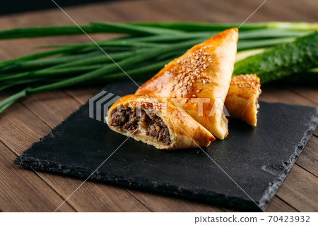 Cut oriental dish baked pie with meat samsa 70423932