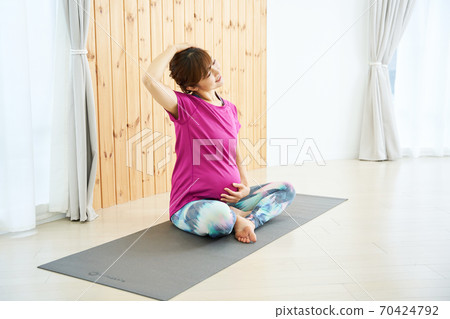Young lady playing maternity exercise 70424792