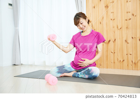 Young lady playing maternity exercise 70424813