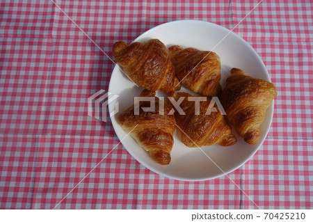 A small croissant in a plate A small croissant in a plate 70425210