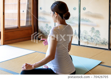 Pregnant woman doing maternity yoga in an old folk house 70426705