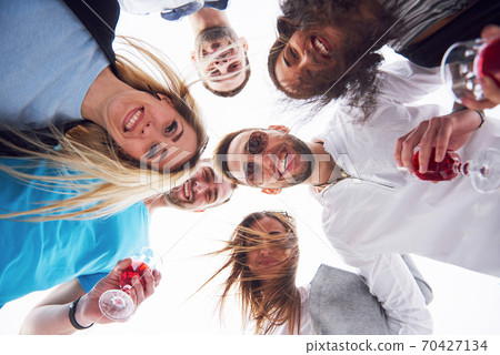 Friends congratulate his friend on his birthday Friends congratulate his friend on his birthday 70427134