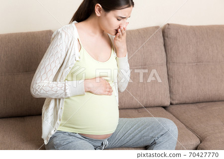 Pregnancy Morning Sickness. Pregnant Woman Having Nausea Feeling Bad in Sofa at the Home 70427770