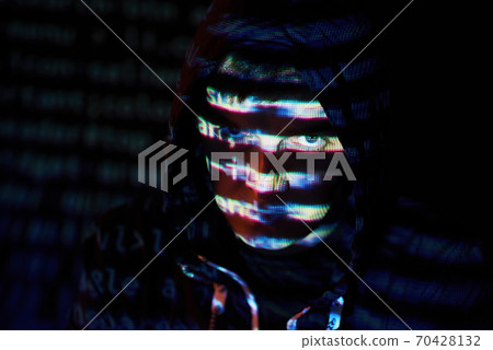 Cyber attack with unrecognizable hooded hacker using virtual reality, digital glitch effect 70428132