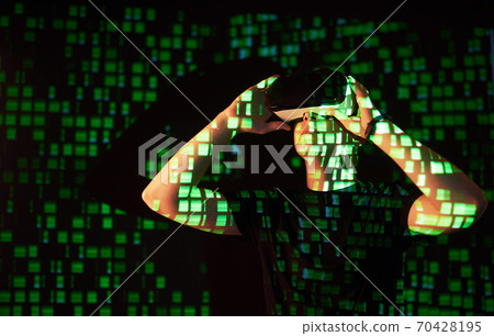 Double exposure of a caucasian man and Virtual reality headset is presumably a gamer or a hacker cracking the code into a secure network or server, with lines of code Double exposure of a caucasian man and Virtual reality headset is presumably a gamer or a hacker cracking the code into a secure network or server, with lines of code 70428195