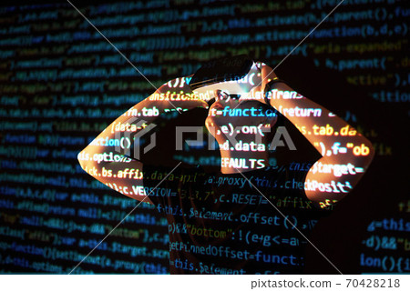 Double exposure of a caucasian man and Virtual reality headset is presumably a gamer or a hacker cracking the code into a secure network or server, with lines of code 70428218