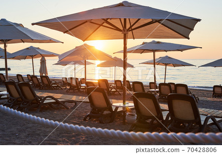 Scenic view of sandy beach on the beach with sun beds and umbrellas open against the sea and mountains. Hotel. Resort. Tekirova-Kemer 70428806