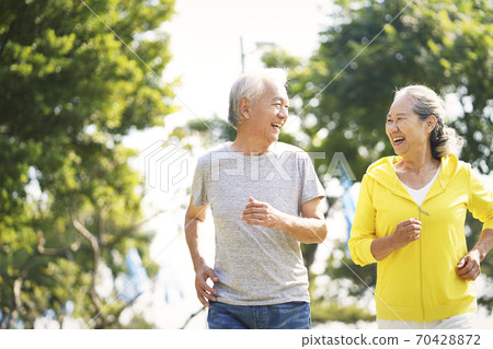 happy chinese senior couple running outdoors happy chinese senior couple running outdoors 70428872