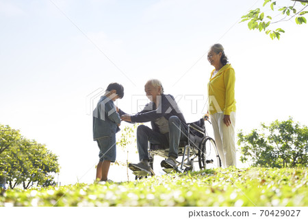 asian grandfather grandmother and grandson having fun outdoors in park asian grandfather grandmother and grandson having fun outdoors in park 70429027