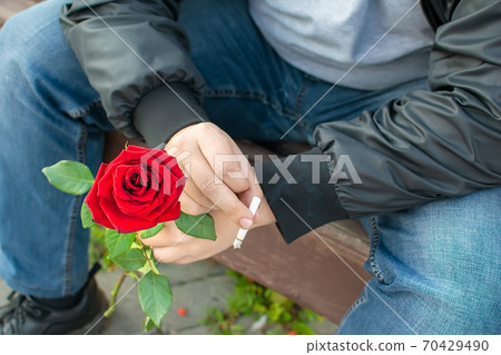 rose and a cigarette in the hand of a romantic Smoking man rose and a cigarette in the hand of a romantic Smoking man 70429490