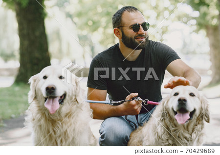 Blind man with guide dog in a summer city Blind man with guide dog in a summer city 70429689