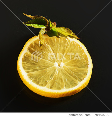 Fresh juicy slices of lemon on a black background 70430209
