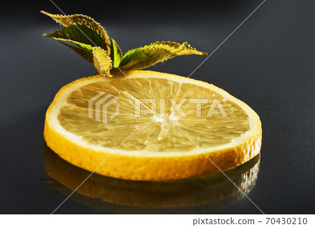 Fresh juicy slices of lemon on a black background 70430210