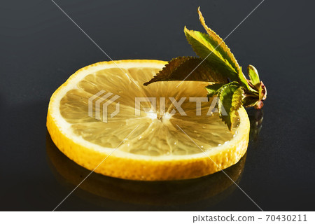 Fresh juicy slices of lemon on a black background 70430211