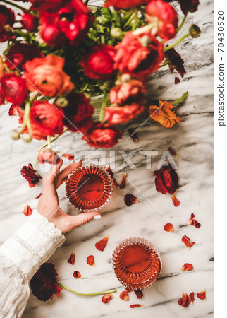 Womans hand holding glass of rose wine and 70430520