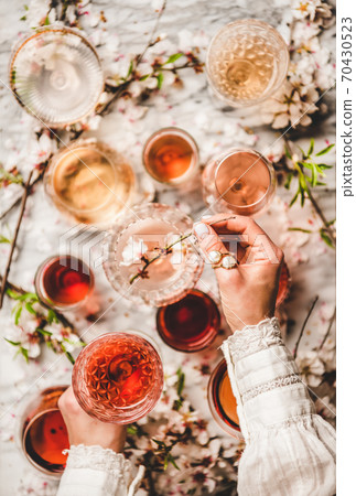 Womans hands over rose wine over white marble 70430523