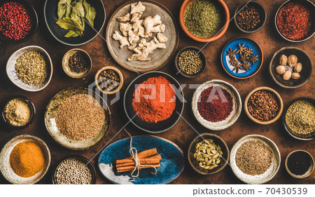 Flat-lay of different spices in bowls over rusty Flat-lay of different spices in bowls over rusty 70430539