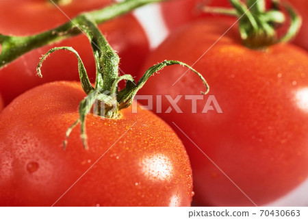 Delicious tomatoes on a chopping board Delicious tomatoes on a chopping board 70430663