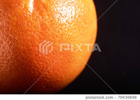 macro fresh orange peel on a black background. macro fresh orange peel on a black background. 70430698