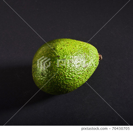 Fresh delicious avocado isolated on a black background Fresh delicious avocado isolated on a black background 70430705