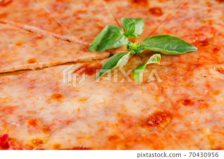 Pizza margarita on wooden board on dark background. Close-up 70430956
