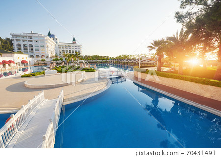 The popular resort Amara Dolce Vita Luxury Hotel. With pools and water parks and recreational area along the sea coast in Turkey at sunset. Tekirova-Kemer 70431491