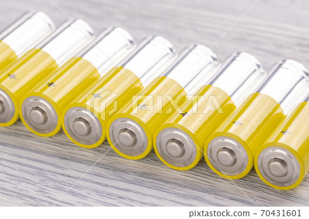 AA batteries on an old white wooden table. The concept of vital energy reserve AA batteries on an old white wooden table. The concept of vital energy reserve 70431601