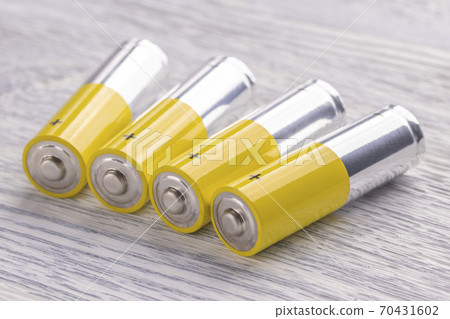 AA batteries on an old white wooden table. Reserve concept for future use AA batteries on an old white wooden table. Reserve concept for future use 70431602