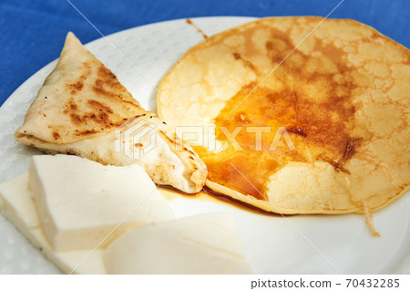 Syrniki laying on a plate isolated over white background. Syrniki laying on a plate isolated over white background. 70432285
