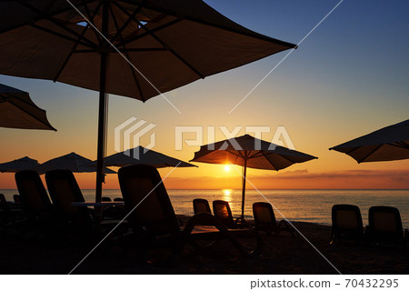 Scenic view of sandy beach on the beach with sun beds and umbrellas open against the sea and mountains. Amara Dolce Vita Luxury Hotel. Resort. Tekirova-Kemer Scenic view of sandy beach on the beach with sun beds and umbrellas open against the sea and mountains. Amara Dolce Vita Luxury Hotel. Resort. Tekirova-Kemer 70432295
