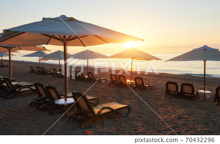 Scenic view of sandy beach on the beach with sun beds and umbrellas open against the sea and mountains. Amara Dolce Vita Luxury Hotel. Resort. Tekirova-Kemer Scenic view of sandy beach on the beach with sun beds and umbrellas open against the sea and mountains. Amara Dolce Vita Luxury Hotel. Resort. Tekirova-Kemer 70432296