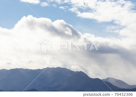 Mountain range in clear weather in contrasting rain clouds. Beautiful picturesque landscape Mountain range in clear weather in contrasting rain clouds. Beautiful picturesque landscape 70432306