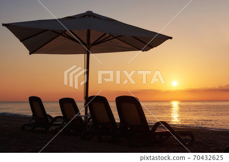 Scenic view of sandy beach on the beach with sun beds and umbrellas open against the sea and mountains. Amara Dolce Vita Luxury Hotel. Resort. Tekirova-Kemer 70432625