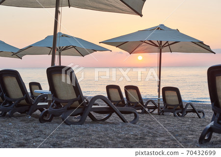 Scenic view of private sandy beach on the beach with sun beds against the sea and mountains. Amara Dolce Vita Luxury Hotel. Resort. Tekirova-Kemer Scenic view of private sandy beach on the beach with sun beds against the sea and mountains. Amara Dolce Vita Luxury Hotel. Resort. Tekirova-Kemer 70432699
