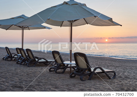 Scenic view of private sandy beach on the beach with sun beds against the sea and mountains. Amara Dolce Vita Luxury Hotel. Resort. Tekirova-Kemer Scenic view of private sandy beach on the beach with sun beds against the sea and mountains. Amara Dolce Vita Luxury Hotel. Resort. Tekirova-Kemer 70432700