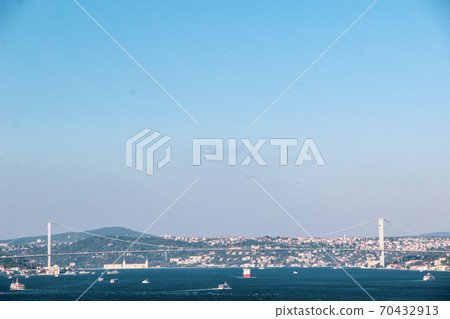 Mosque minarets and Bosphorus bridge in Istanbul in Turkey and the sea of Marmara on background Mosque minarets and Bosphorus bridge in Istanbul in Turkey and the sea of Marmara on background 70432913