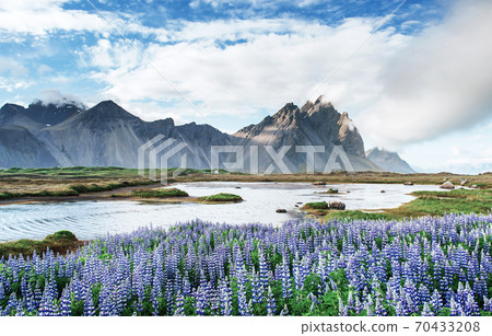 Picturesque views of the river and mountains in Iceland. 70433208