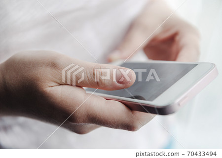 smartphone, phone in female hands of a person on a smartphone, phone in female hands of a person on a 70433494