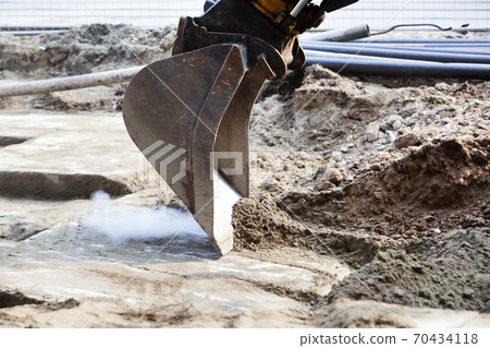 Closeup of an excavator scraping sand 70434118