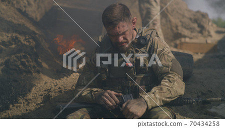 Male soldier resting during war Male soldier resting during war 70434258