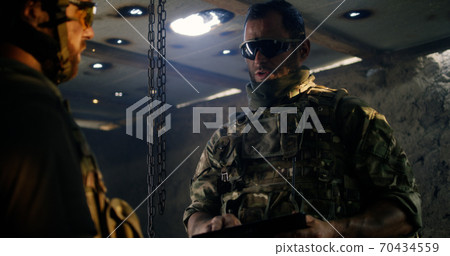 Soldiers discussing plan on base Soldiers discussing plan on base 70434559