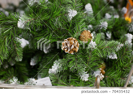brown cone on artificial Christmas tree, close-up 70435432