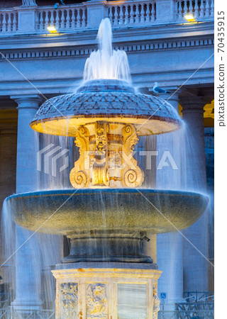 Illuminated Bernini Fountain at St Peters Basilica in the evening dusk. St Peters Square, Vatican 70435915