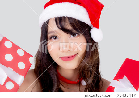 Beautiful portrait young asian woman happy holding red gift box with excited in xmas holiday. 70439417
